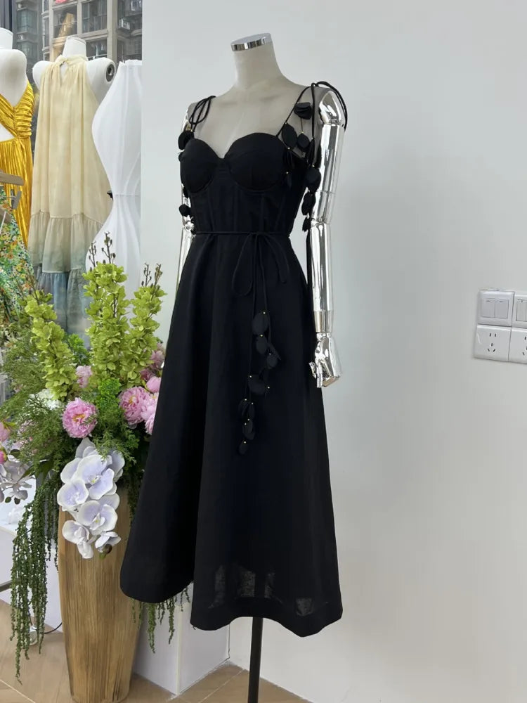 JNMC Black Floral Lace Vacation Dress – Beach-Ready Elegance for WomenJNMC Black Temperament Design Sense Spring And Summer New Flower Lace Shoulder Strap Vacation Beach Style Dress For Women 2024
