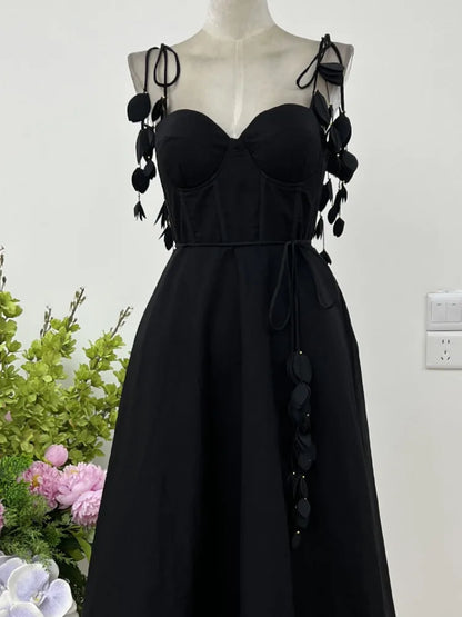 JNMC Black Floral Lace Vacation Dress – Beach-Ready Elegance for WomenJNMC Black Temperament Design Sense Spring And Summer New Flower Lace Shoulder Strap Vacation Beach Style Dress For Women 2024