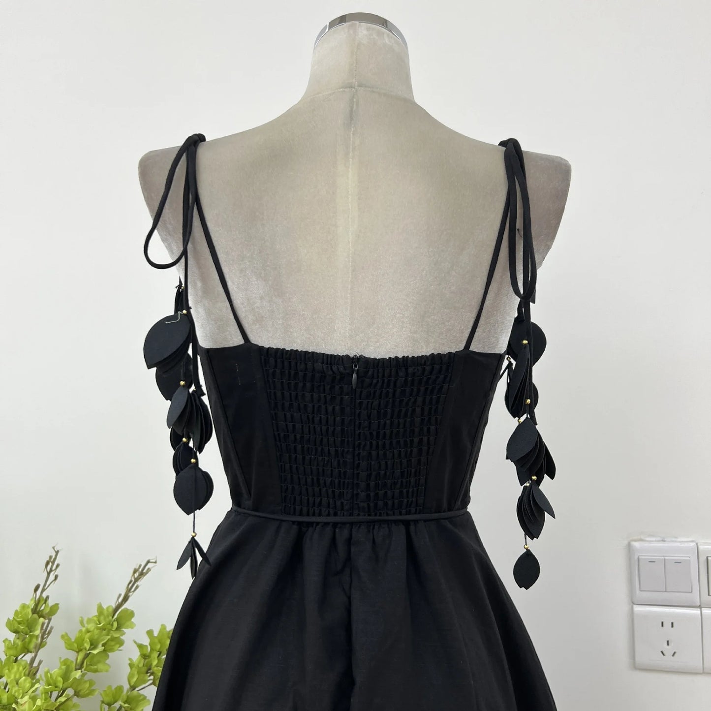 JNMC Black Floral Lace Vacation Dress – Beach-Ready Elegance for WomenJNMC Black Temperament Design Sense Spring And Summer New Flower Lace Shoulder Strap Vacation Beach Style Dress For Women 2024
